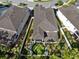 This aerial view highlights a home with a putting green in the fenced backyard at 14138 Alafaya Oak Bnd, Orlando, FL 32828