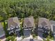 Aerial view of three homes with fenced yards and manicured lawns at 14138 Alafaya Oak Bnd, Orlando, FL 32828