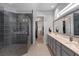 Spa-like bathroom with dual sinks, a walk-in shower, and a view of the closet at 14138 Alafaya Oak Bnd, Orlando, FL 32828
