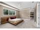 Comfortable bedroom with stylish bed frame and view into game room at 14138 Alafaya Oak Bnd, Orlando, FL 32828