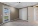 Bedroom with carpet, closet and door leading to a balcony with railings at 14138 Alafaya Oak Bnd, Orlando, FL 32828