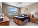 Cozy bedroom with a ceiling fan and large window that allows natural light at 14138 Alafaya Oak Bnd, Orlando, FL 32828