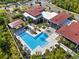 A captivating aerial view of a community pool area with ample seating and umbrellas at 14138 Alafaya Oak Bnd, Orlando, FL 32828