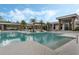 The community pool area features comfortable lounge chairs, umbrellas, and palm trees at 14138 Alafaya Oak Bnd, Orlando, FL 32828