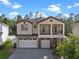 Charming two-story home featuring a front-facing balcony and a three car garage at 14138 Alafaya Oak Bnd, Orlando, FL 32828