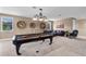 Well-appointed game room with a pool table, comfortable seating, and stylish decor at 14138 Alafaya Oak Bnd, Orlando, FL 32828