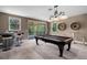 Entertaining game room featuring a pool table, bar, and outdoor access at 14138 Alafaya Oak Bnd, Orlando, FL 32828
