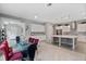 Spacious open-concept kitchen and dining area with island, stainless appliances, and tile flooring at 14138 Alafaya Oak Bnd, Orlando, FL 32828