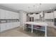 Modern kitchen with white cabinets, pendant lights, and stainless steel appliances at 14138 Alafaya Oak Bnd, Orlando, FL 32828