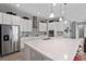 Spacious island kitchen with stainless steel appliances, white cabinets, and pendant lighting at 14138 Alafaya Oak Bnd, Orlando, FL 32828