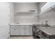Clean laundry room with modern washer/dryer, sink, counter space and storage cabinets at 14138 Alafaya Oak Bnd, Orlando, FL 32828