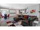Open-concept living room and kitchen with gray walls, tile floors, and modern furniture at 14138 Alafaya Oak Bnd, Orlando, FL 32828