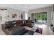 Spacious living room with a sectional sofa and sliding glass doors to the patio at 14138 Alafaya Oak Bnd, Orlando, FL 32828