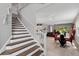 Open-concept living space with dining area, stairs, and view of kitchen at 14138 Alafaya Oak Bnd, Orlando, FL 32828