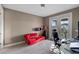 Office with a red chaise lounge, desk, and a door that leads to a balcony at 14138 Alafaya Oak Bnd, Orlando, FL 32828