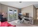 Office space includes a desk setup and a door leading to a balcony with a view at 14138 Alafaya Oak Bnd, Orlando, FL 32828