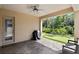 The covered brick patio overlooks a putting green and wooded area at 14138 Alafaya Oak Bnd, Orlando, FL 32828