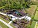 Aerial view of a fenced community playground with modern play structures and landscaping at 14138 Alafaya Oak Bnd, Orlando, FL 32828