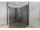Large walk-in shower with glass door and gray tile at 14138 Alafaya Oak Bnd, Orlando, FL 32828