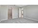 Neutral bedroom with carpeted floors, open doorway, and ample natural light at 1459 Santorini Way, Tavares, FL 32778
