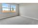 Simple bedroom with a neutral carpet, large window to the exterior, and white trim at 1459 Santorini Way, Tavares, FL 32778
