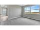 Well-lit bedroom featuring soft carpet, large windows, and neutral walls at 1459 Santorini Way, Tavares, FL 32778