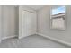 Bedroom with neutral carpet, double closet, and a bright window at 1459 Santorini Way, Tavares, FL 32778