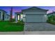 Charming home with modern garage, complemented by lush landscaping and a beautiful lawn at 1459 Santorini Way, Tavares, FL 32778