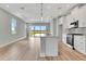 Bright open kitchen with stainless steel appliances, center island, and seamless access to the backyard at 1459 Santorini Way, Tavares, FL 32778