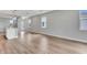 Contemporary living room with light wood floors, large windows, and an open layout at 1459 Santorini Way, Tavares, FL 32778