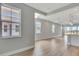 Bright open living space with light wood floors, large windows, and seamless access to the kitchen at 1459 Santorini Way, Tavares, FL 32778