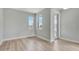Bright, open living room featuring light wood floors and windows offering an exterior view at 1459 Santorini Way, Tavares, FL 32778