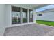 Covered patio featuring gray brick flooring, seamless indoor-outdoor flow at 1459 Santorini Way, Tavares, FL 32778