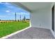 Covered patio with brick flooring and expansive backyard at 1459 Santorini Way, Tavares, FL 32778