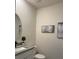 Modern half bathroom with a stylish sink, framed mirror, and decorative wall art at 1832 Katz Crossing Dr, Kissimmee, FL 34744
