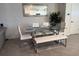 Elegant dining area with a glass-top table, white leather chairs, and modern decor at 1832 Katz Crossing Dr, Kissimmee, FL 34744