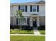 Charming townhome exterior featuring a well-maintained front lawn and decorative shutters at 1832 Katz Crossing Dr, Kissimmee, FL 34744
