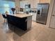Bright kitchen with white cabinets, stainless steel appliances, and a large center island at 1832 Katz Crossing Dr, Kissimmee, FL 34744