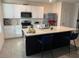 Modern kitchen with white cabinets, an island with seating, and stainless steel appliances at 1832 Katz Crossing Dr, Kissimmee, FL 34744