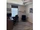 Bright home office featuring a modern desk setup, floating shelves, and comfortable seating area at 1832 Katz Crossing Dr, Kissimmee, FL 34744