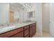 Bathroom with double vanity featuring granite countertops and ample cabinet space at 196 Morning Glory Dr, Lake Mary, FL 32746