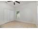 This bedroom features tile flooring, neutral paint and a double door closet at 196 Morning Glory Dr, Lake Mary, FL 32746