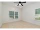 This bright bedroom offers tiled floors and windows with wood blinds at 196 Morning Glory Dr, Lake Mary, FL 32746
