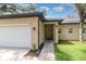 Close-up of the inviting front entrance with a two-car garage and well-maintained lawn, highlighting the curb appeal at 196 Morning Glory Dr, Lake Mary, FL 32746