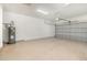 This spacious garage features durable flooring and an automatic door at 196 Morning Glory Dr, Lake Mary, FL 32746