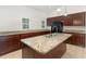 Kitchen features granite countertops, modern island with stainless steel sink, and plentiful cabinet space at 196 Morning Glory Dr, Lake Mary, FL 32746
