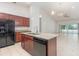 Bright kitchen with granite countertops, stainless steel appliances and large island, and open floor plan at 196 Morning Glory Dr, Lake Mary, FL 32746