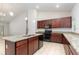 Bright open kitchen with granite countertops, island, stainless steel sink, and modern appliances at 196 Morning Glory Dr, Lake Mary, FL 32746
