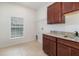This laundry room features tile floors, granite countertops and updated cabinetry at 196 Morning Glory Dr, Lake Mary, FL 32746
