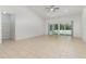 Spacious living room with tile flooring, a ceiling fan, and sliding glass doors leading to the outdoor pool area at 196 Morning Glory Dr, Lake Mary, FL 32746